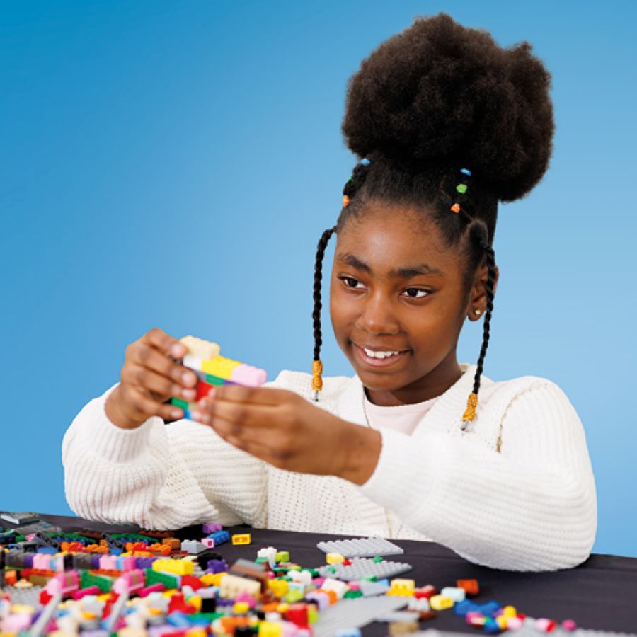 Girl building with lego bricks