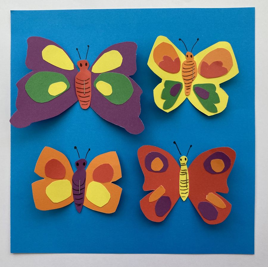 Four colouful paper butterflies on a blue background