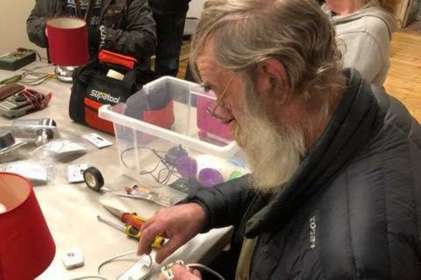 Man repairing a lamp.