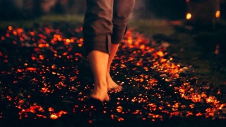 Bare feet walking across burning coals