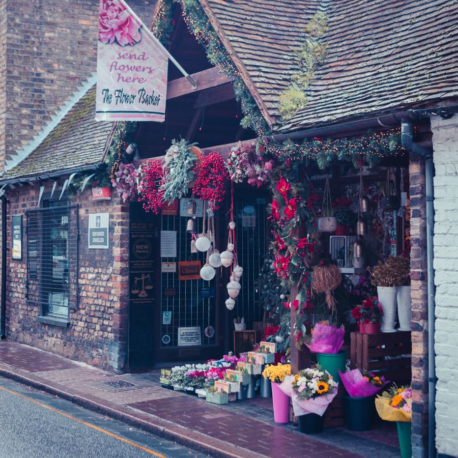 Exterior of The Flower Basket in Sandwich with colourful berries and flowers.