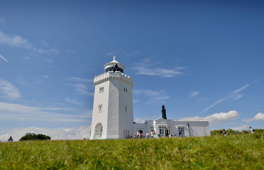 Whitewashed lighthouse with a blue sky above