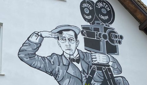 Black and white mural of Buster Keaton on side of a building