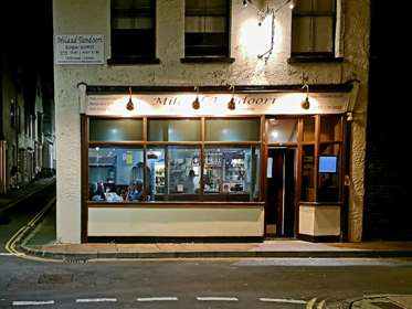 View of the Milaad Tandoori frontage at night