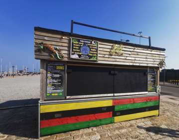 Wooden street food cabin with chalkboard menu.