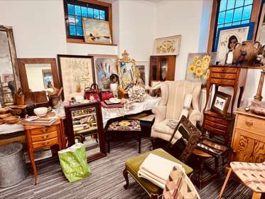 An arrangement of antique furniture and paintings for sale