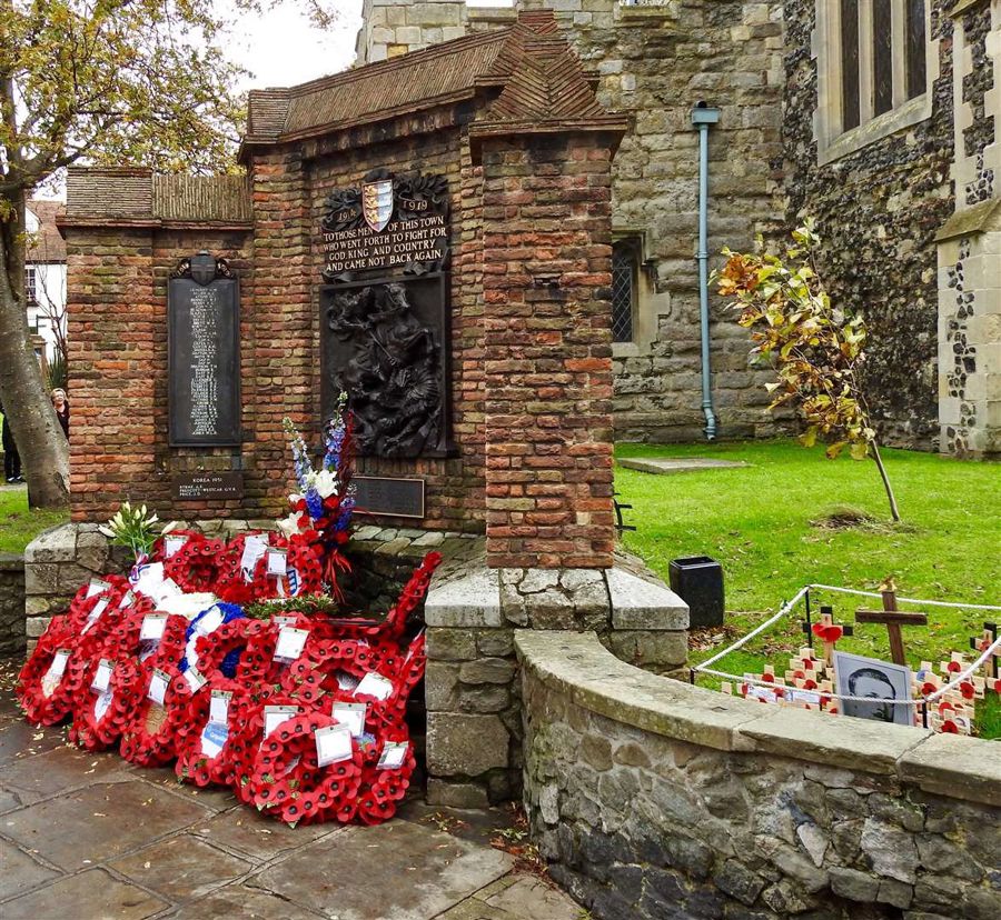 Sandwich War Memorial with poppy wreaths and crosses