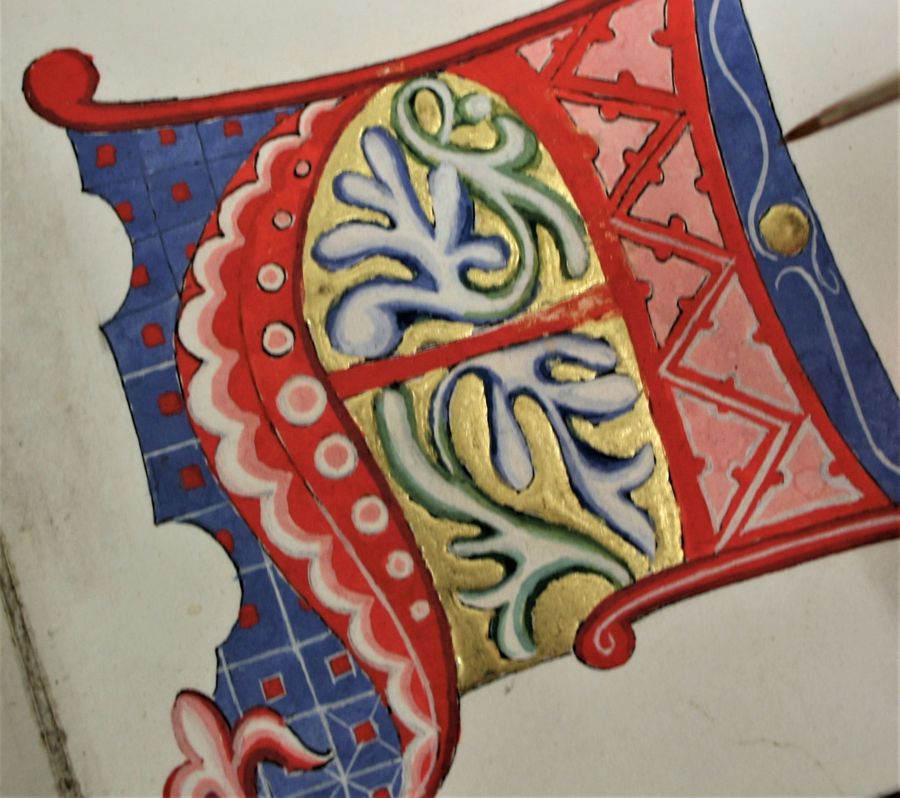 Calligraphy painting in red, blue and gold paint.